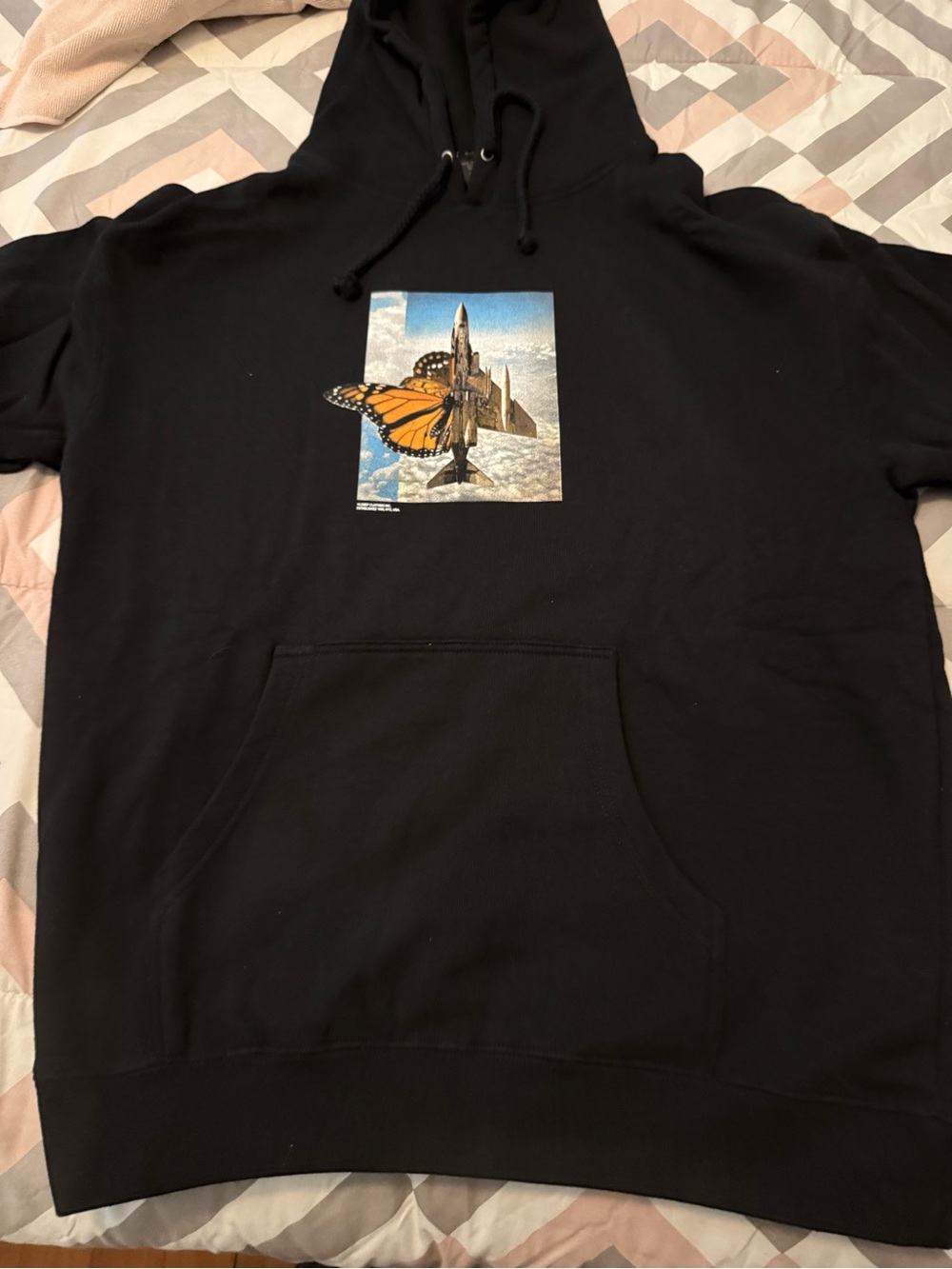 10. Deep Black Graphic Pullover Hoodie with Orange Butterfly Print